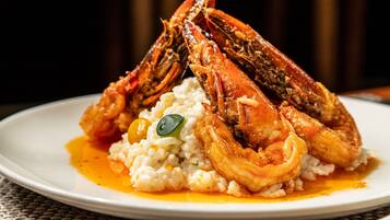 A plate with two cooked crabs and a serving of rice.