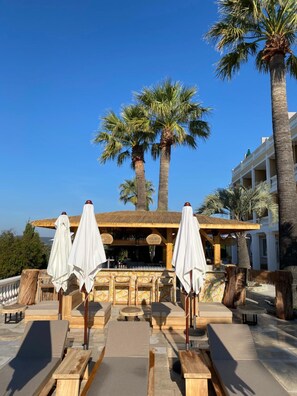 Seasonal outdoor pool, open 8:00 AM to 8:00 PM, pool umbrellas