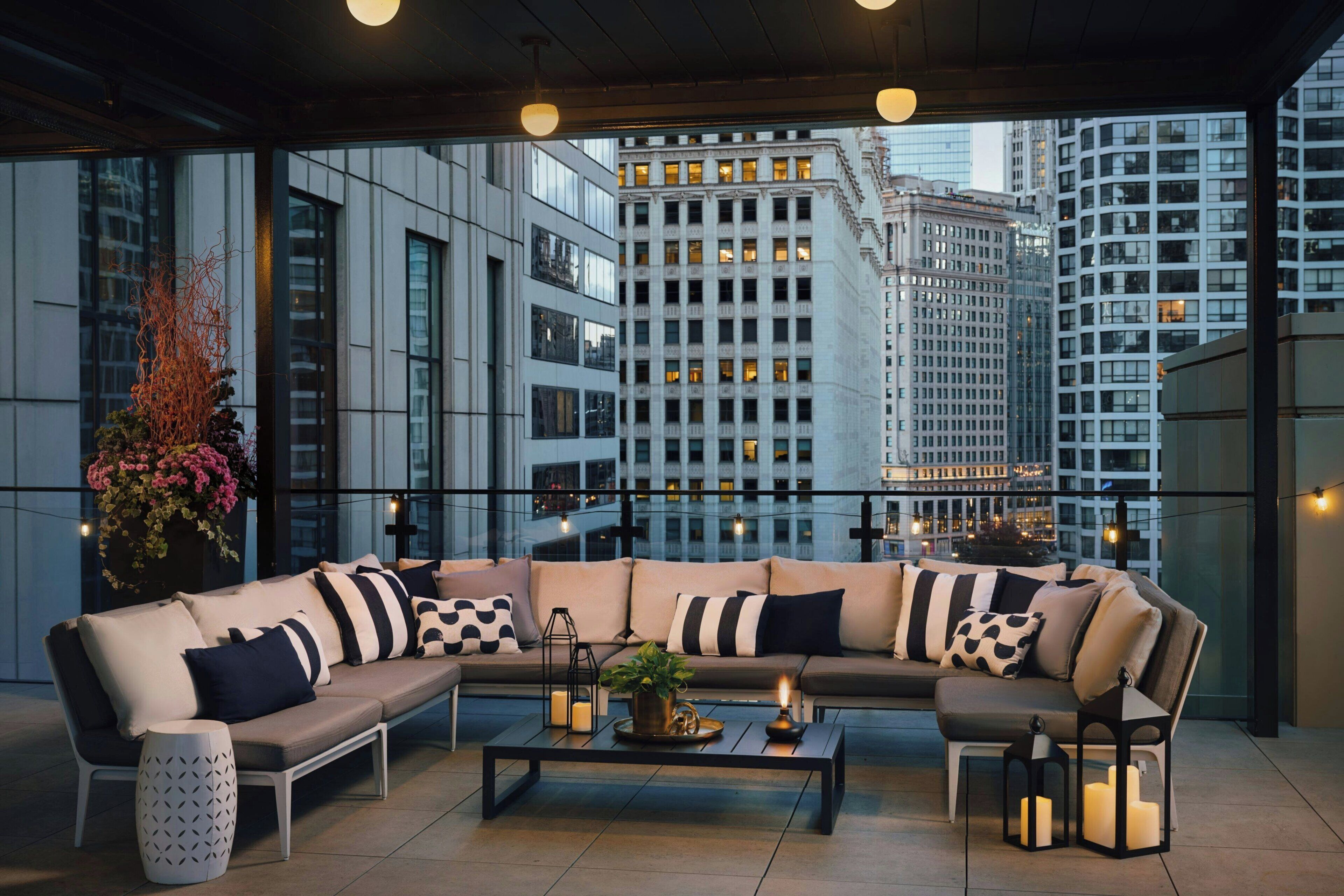 A modern living room with a sectional sofa, a coffee table, and a potted plant.