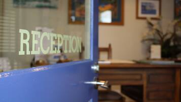 A reception area with a blue door and a sign that reads "RECEPTION".