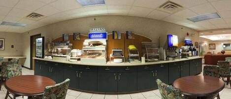 A breakfast area with a counter, seating, and a sign that reads "EXPRESS Start".
