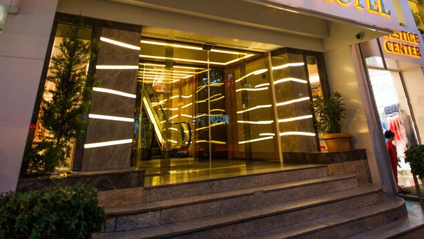 The exterior of the Prestige Hotel with a prominent illuminated sign, a glass entrance, and a visible staircase leading to the entrance. - Prestige Hotel Old City (Istanbul)