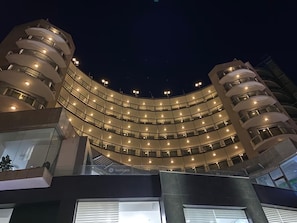 A modern building with a curved facade, multiple balconies, and a glass entrance. - The Preluna Hotel (Sliema)