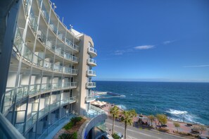 Enjoy panoramic ocean views from the hotel's spacious balconies, overlooking the swimming pool and coastal promenade.