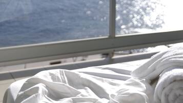Enjoy the ocean view from the comfort of your room, featuring a large window and a clean, uncluttered space.