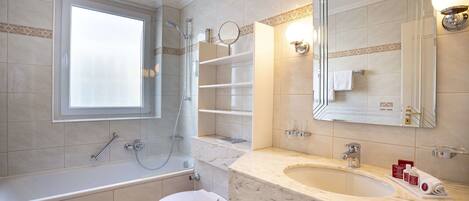 A modern bathroom with a bathtub, toilet, and sink.