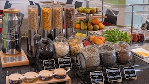 A breakfast buffet with various food options and a coffee station. - Sorat Hotel Cottbus (Cottbus)