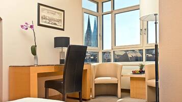 Hypo-allergenic bedding, desk, laptop workspace, blackout drapes