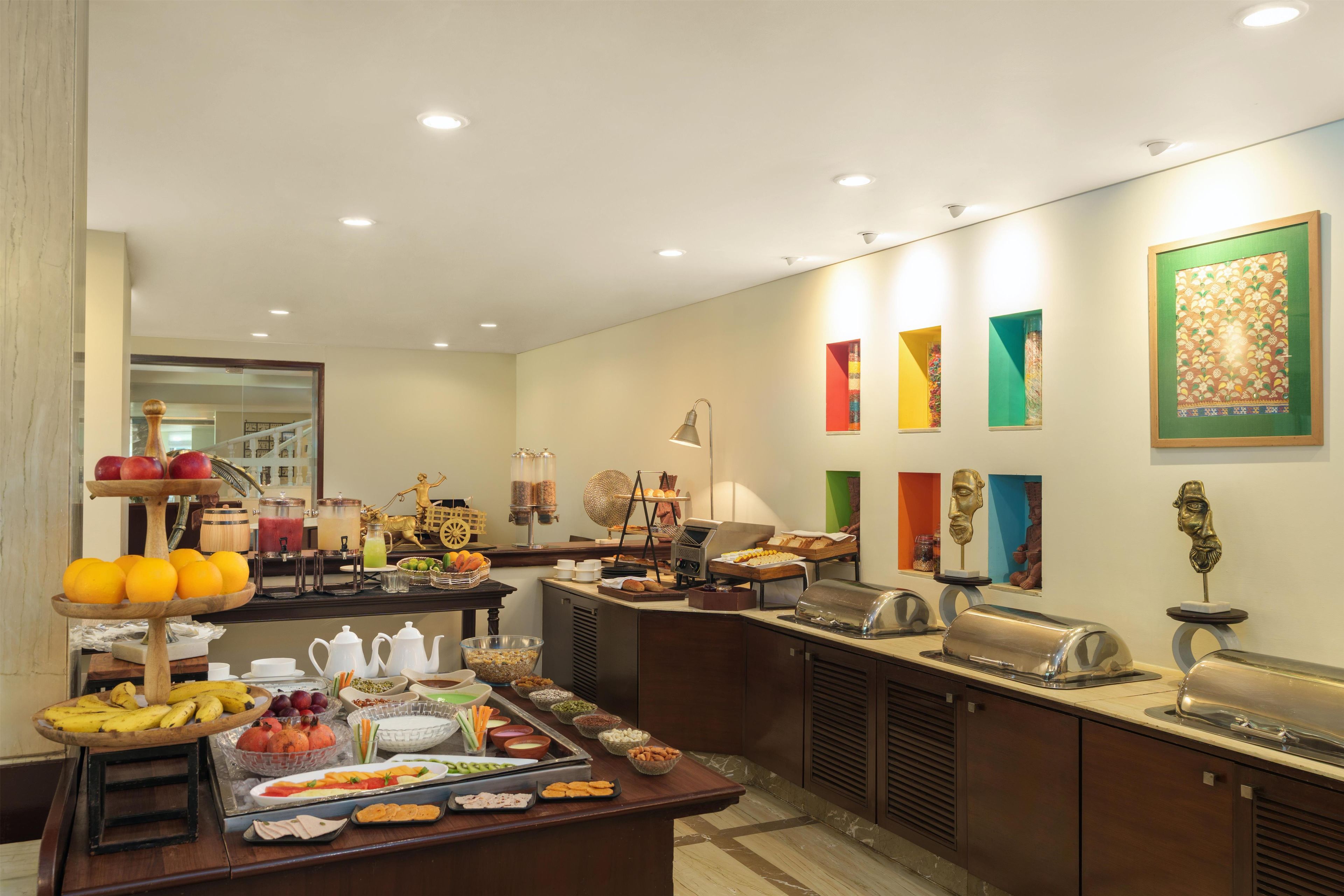 A buffet setup with various food items and a coffee station.