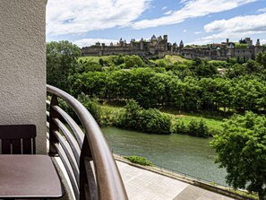 A riverside view with a historic castle in the background. - Tribe Carcassonne (Carcassonne)
