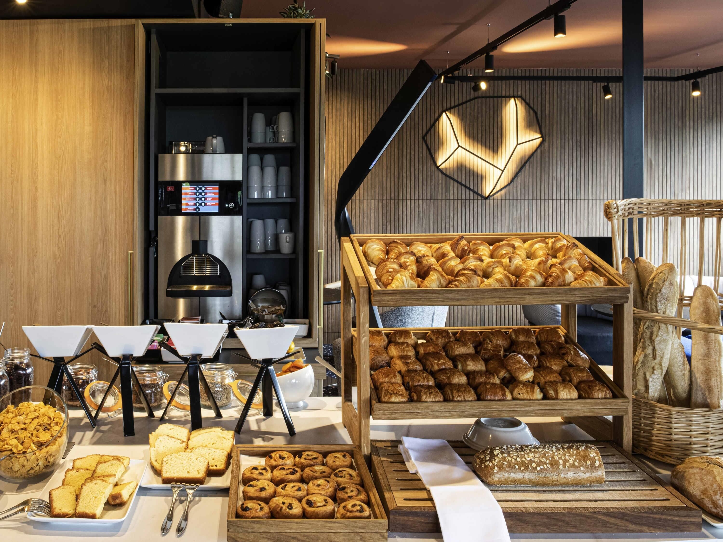 Ein reichhaltiges Frühstücksbuffet mit verschiedenen Backwaren, Brot und Müsli.