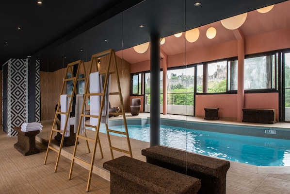 Indoor pool, open 10:00 AM to 9:00 PM, pool loungers