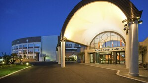 A modern hotel entrance with a large arched canopy and a sign reading "Roma Aurelia Antica". - Hotel Roma Aurelia Antica (Rome)