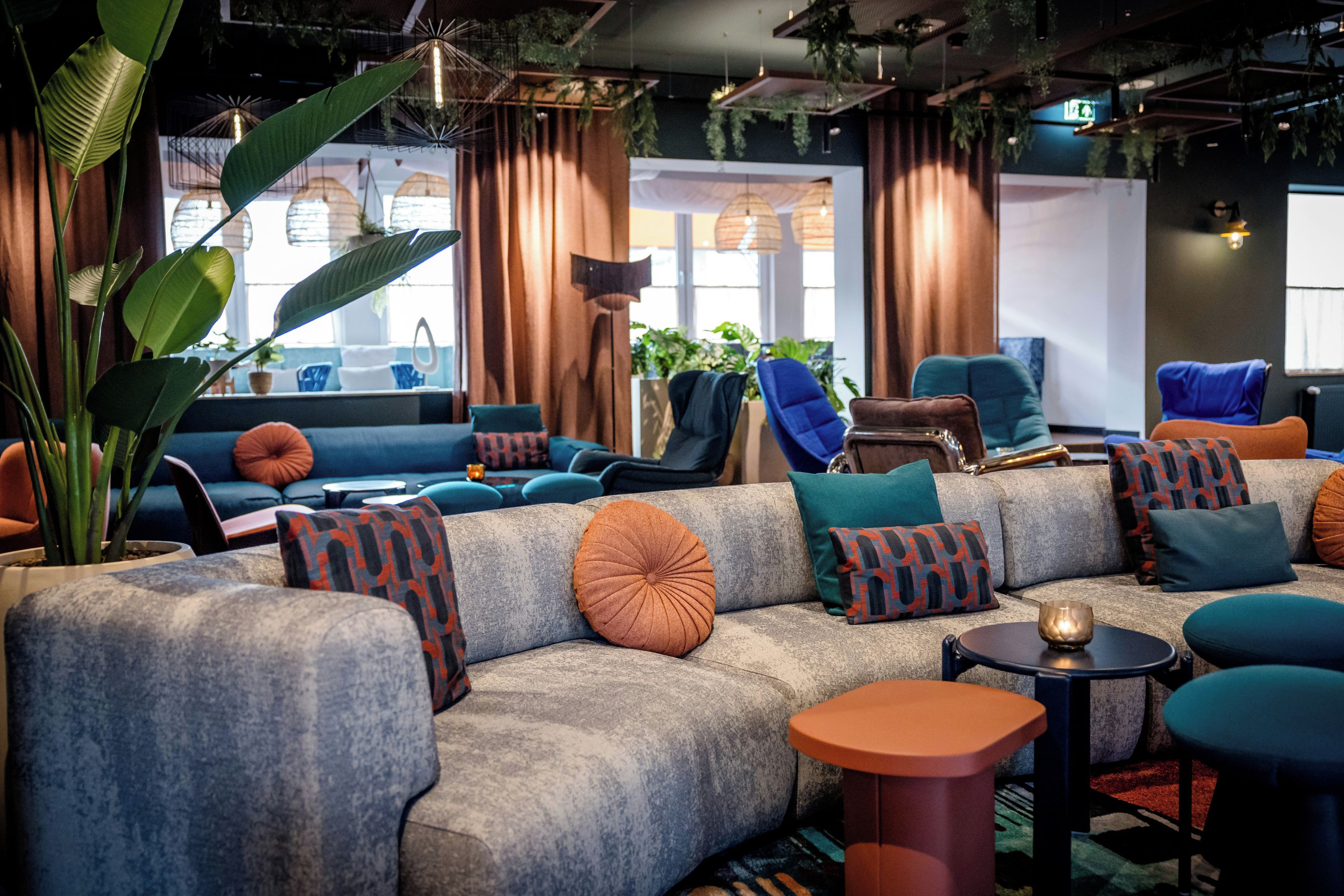 A modern lounge area with sofas, armchairs, and a coffee table.