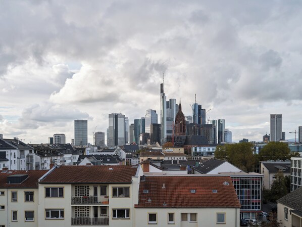 A cityscape with a mix of modern high-rise buildings and traditional architecture.