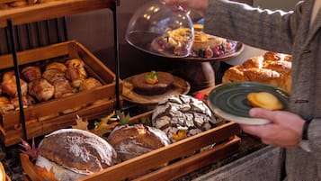 A buffet with various baked goods and pastries.