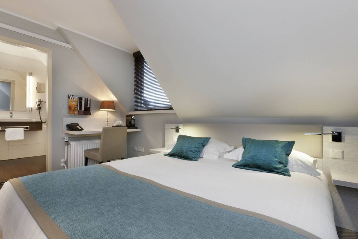 Premium bedding, desk, laptop workspace, blackout drapes