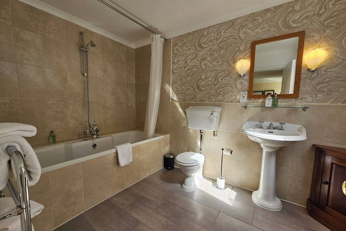comfy king room | bathroom | hair dryer, towels