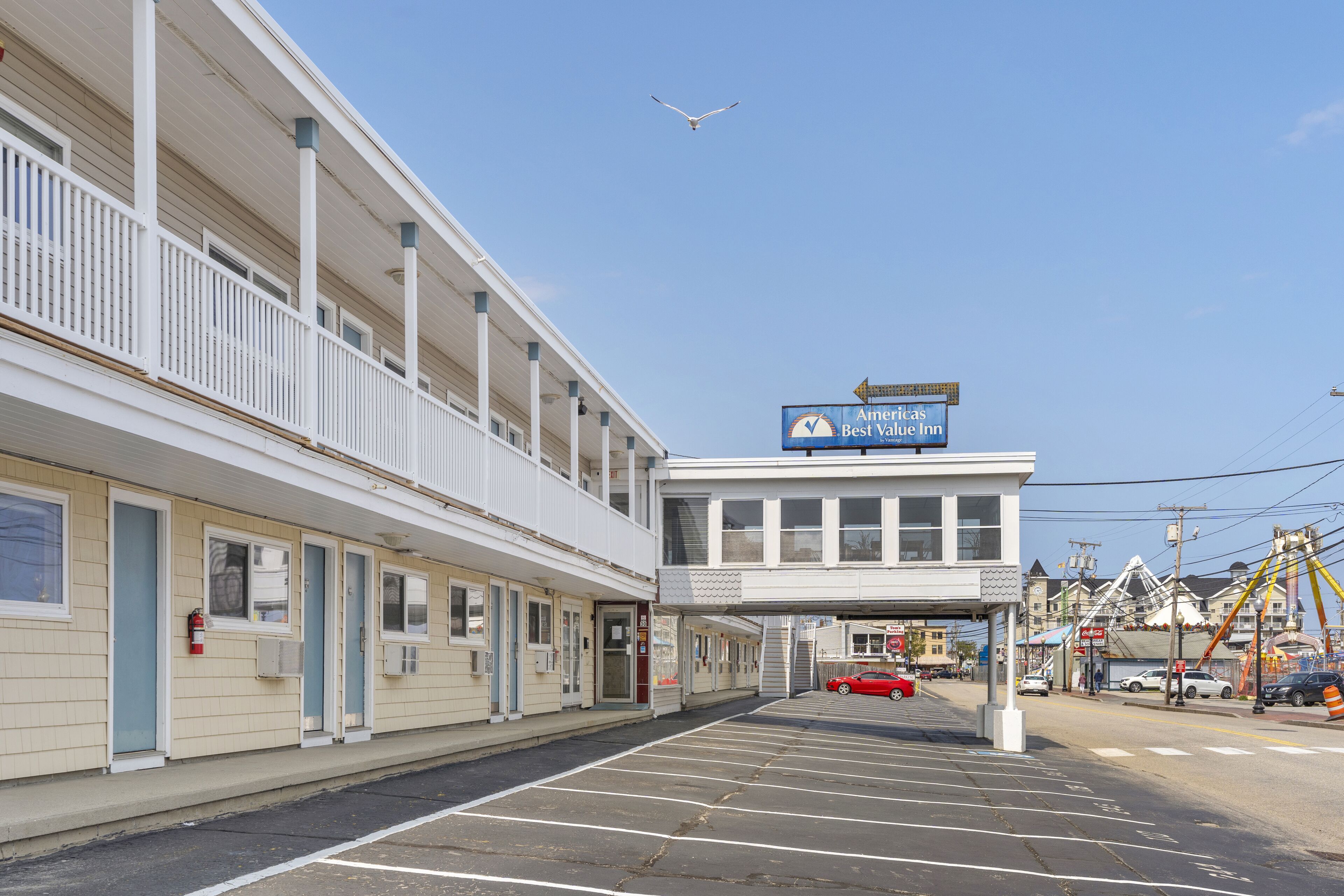 Un motel con un letrero que dice 'Americas Best Value Inn' y un estacionamiento al frente.