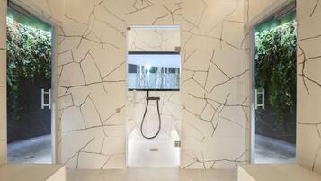 A modern bathroom with a unique marble wall design, a central shower area, and vertical gardens on either side.