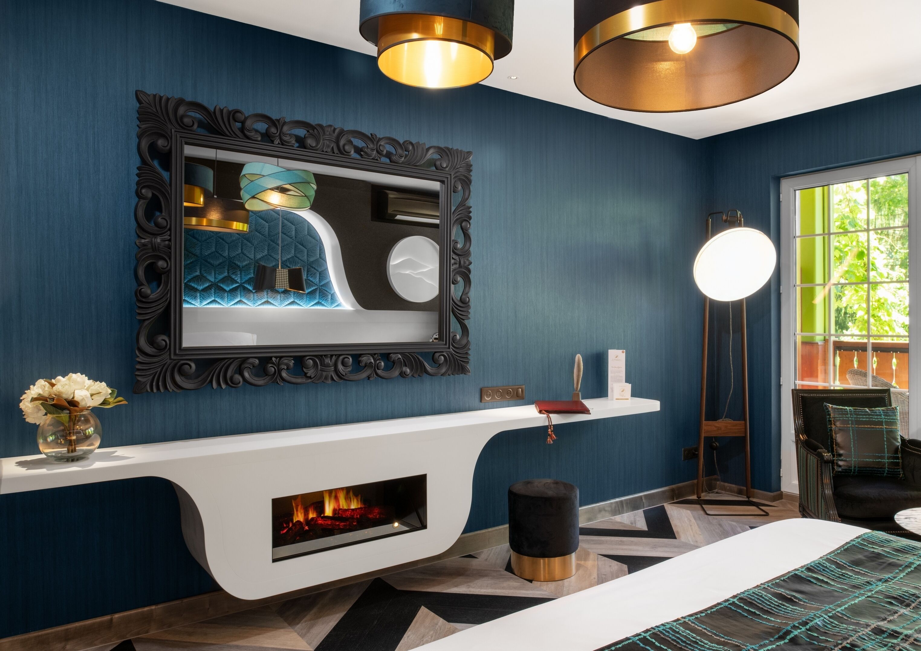 A modern bathroom with a large mirror, a fireplace, and a vanity with a sink.