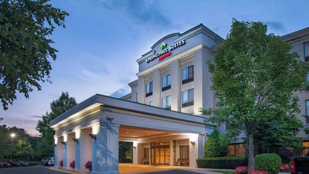 A hotel entrance with a covered walkway, columns, and a sign for Springhill Suites Marriott. - SpringHill by Marriott Centreville/Chantilly (Centreville)
