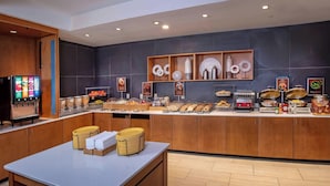 A modern breakfast bar with a self-service beverage station, a variety of food options, and a clean, contemporary design. - SpringHill by Marriott Centreville/Chantilly (Centreville)