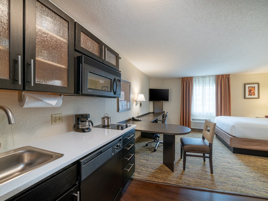 Premium bedding, desk, laptop workspace, blackout drapes