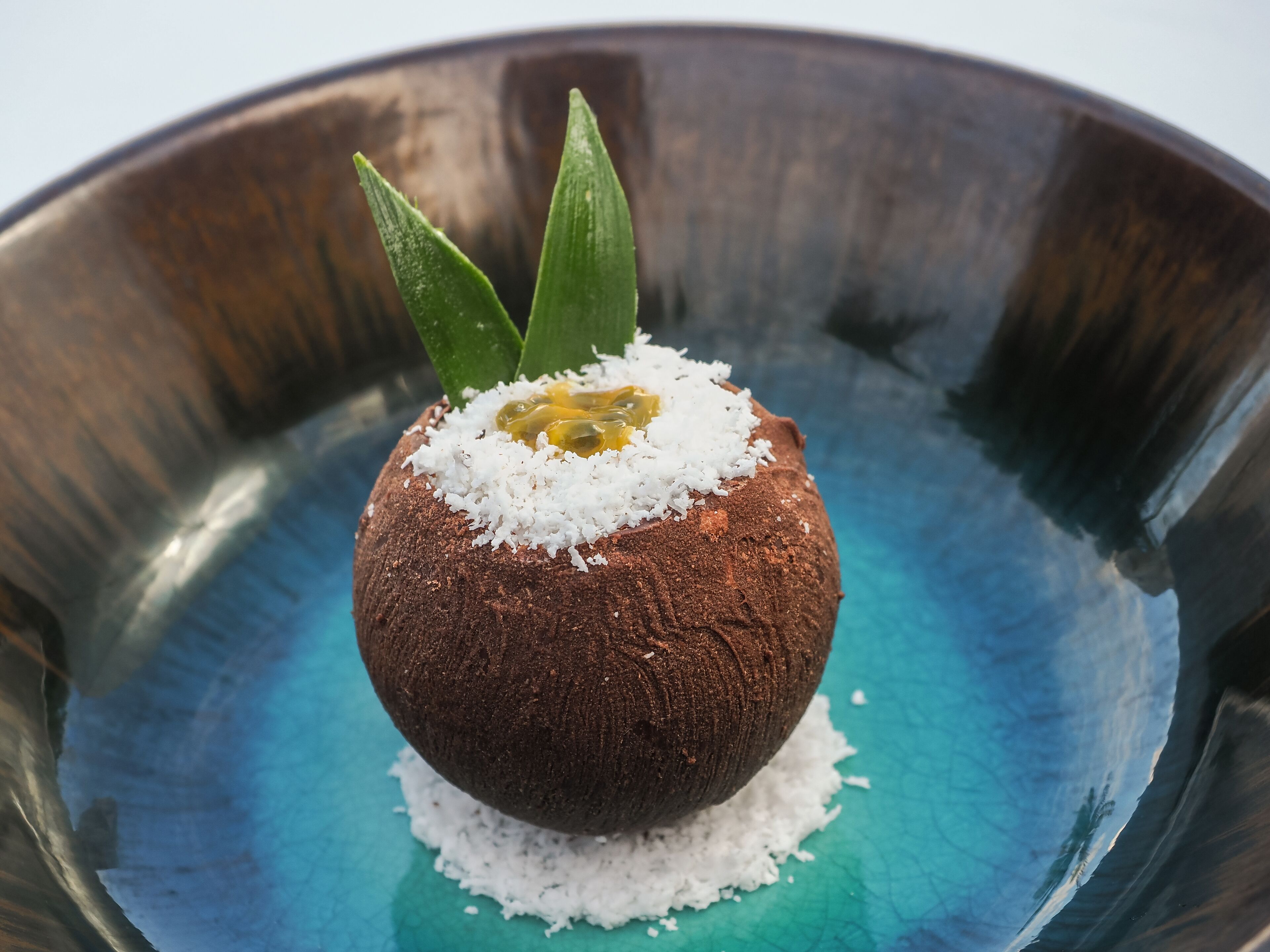 A dessert in a metallic bowl.