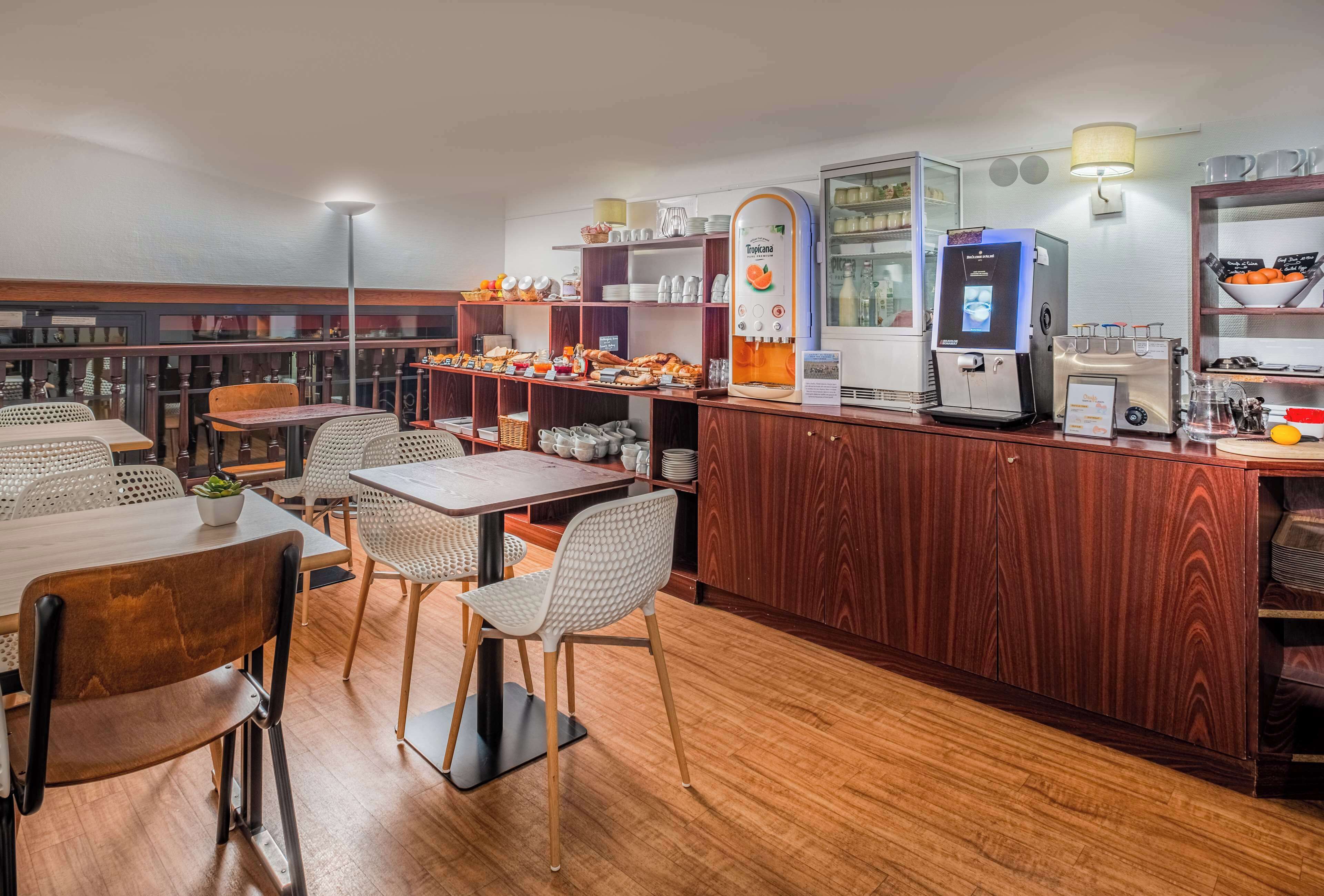 A restaurant with wooden furniture, a coffee machine, and a variety of food items on display.