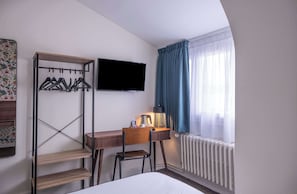 Premium bedding, desk, laptop workspace, blackout drapes