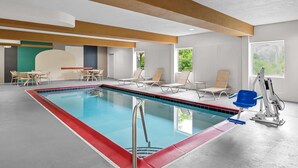 An indoor swimming pool with a red border, lounge chairs, and a blue chairlift. - Comfort Inn Ruther Glen near Kings Dominion (Ruther Glen)