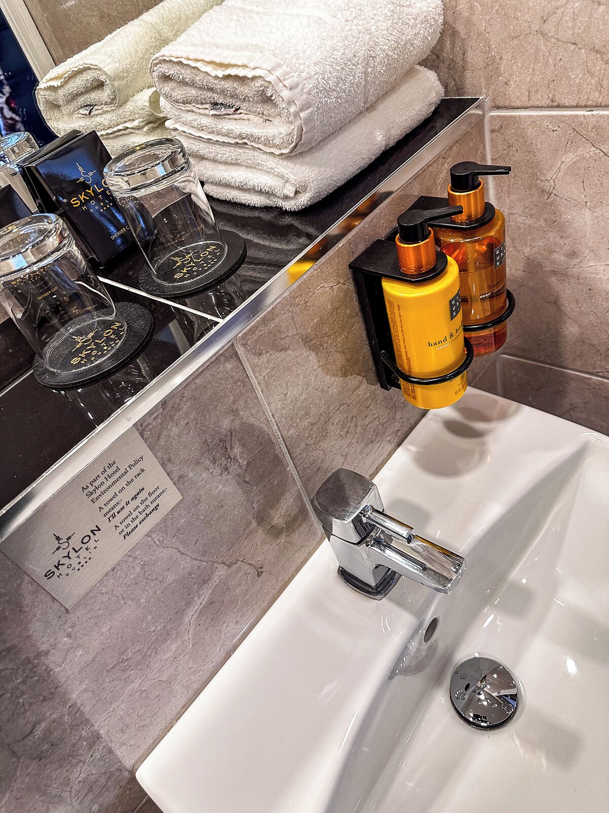 designer toiletries, hair dryer, towels