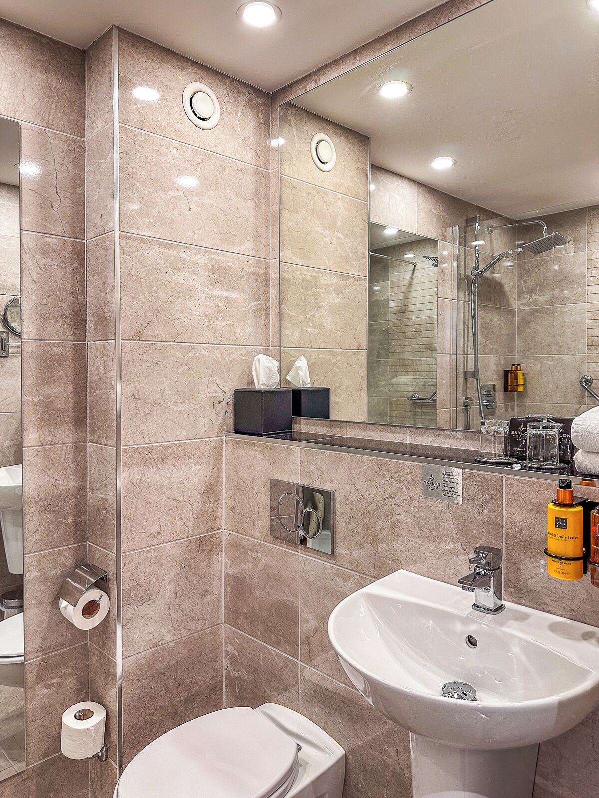 designer toiletries, hair dryer, towels