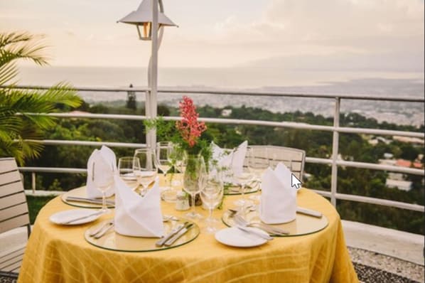 A table set for dining with a yellow tablecloth, white napkins, and glassware.