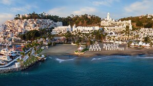 A coastal town with a marina, beach, and white buildings. - Las Hadas By Brisas (Manzanillo)