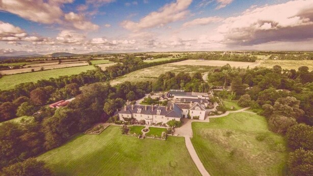 A large estate with multiple buildings, expansive green fields, and a clear sky. - Dunbrody Country House Hotel (Arthurstown)
