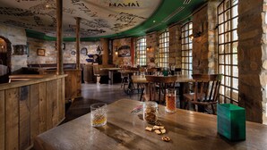 A restaurant with stone walls, wooden tables, and a ceiling with graffiti. - Seminaris Seehotel Potsdam (Potsdam)