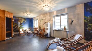 Relax in this stylish room with a ceiling light fixture, large window, and comfortable seating area.