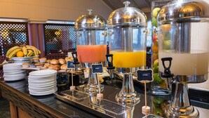 A buffet with various food items and beverage dispensers. - Mercure Johannesburg Randburg Hotel (Randburg)