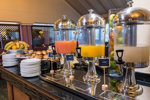 A buffet with various food items and beverage dispensers. - Mercure Johannesburg Randburg Hotel (Randburg)