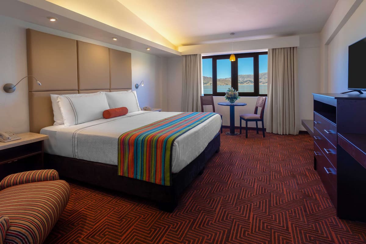 double room, 1 king bed, lake view | 1 bedroom, down duvets, minibar, in-room safe