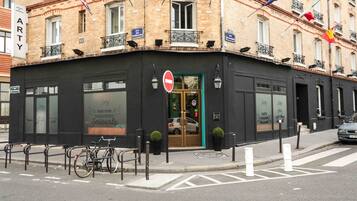 A black building with a sign reading "ARTY" and a no entry sign.