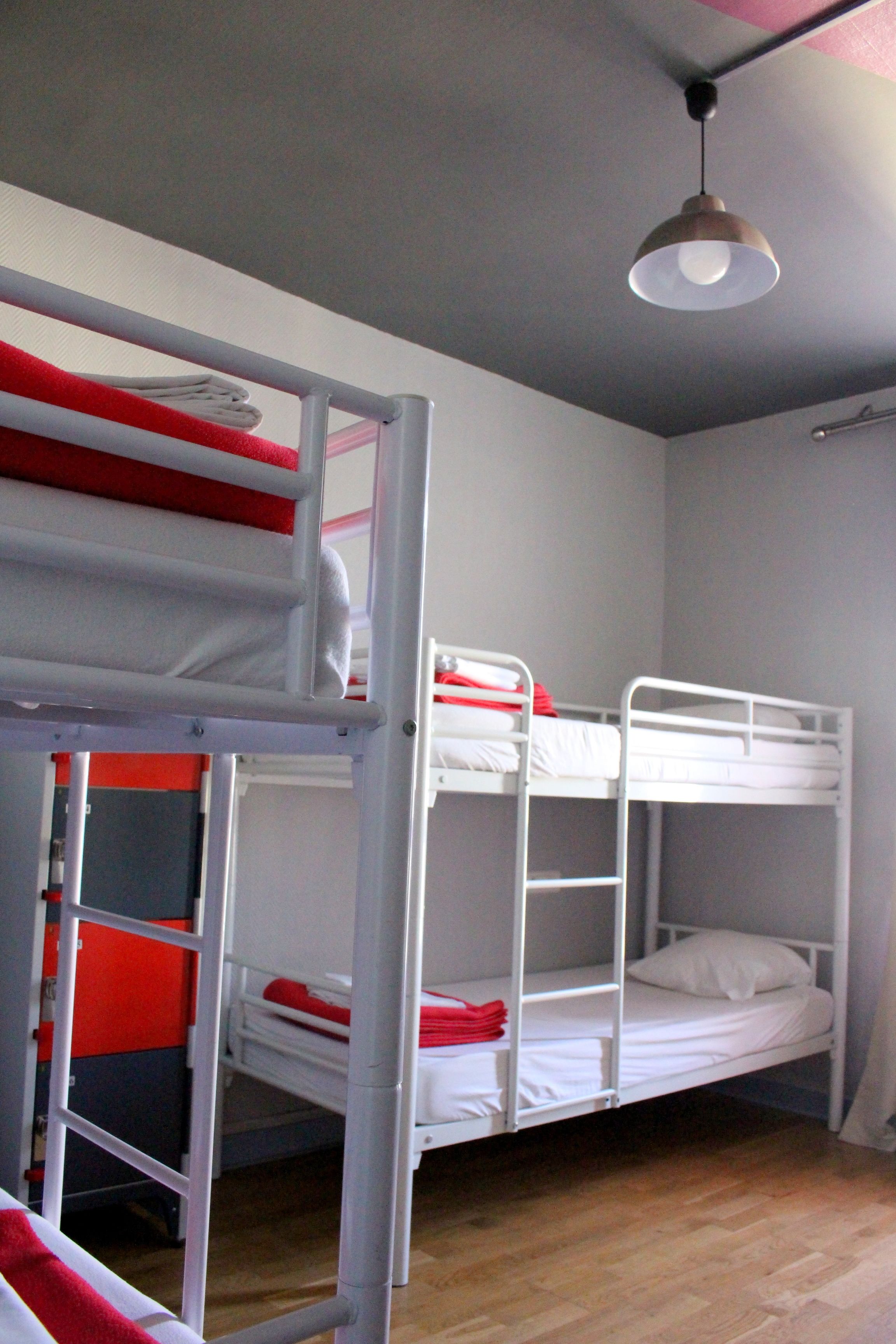 A bunk bed room with a ceiling light fixture.
