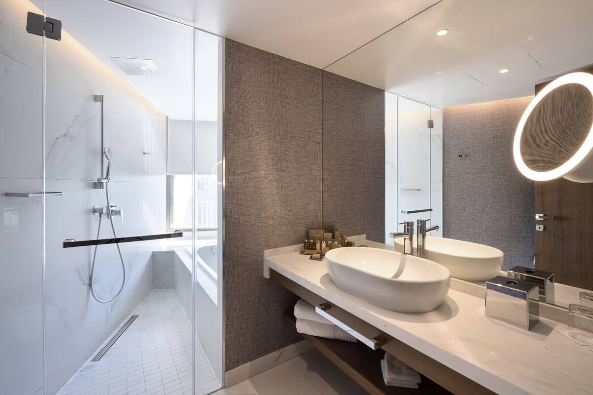 junior suite, city view | bathroom | rainfall showerhead, hair dryer, bathrobes, slippers