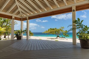 On the beach, white sand, sun loungers, beach umbrellas