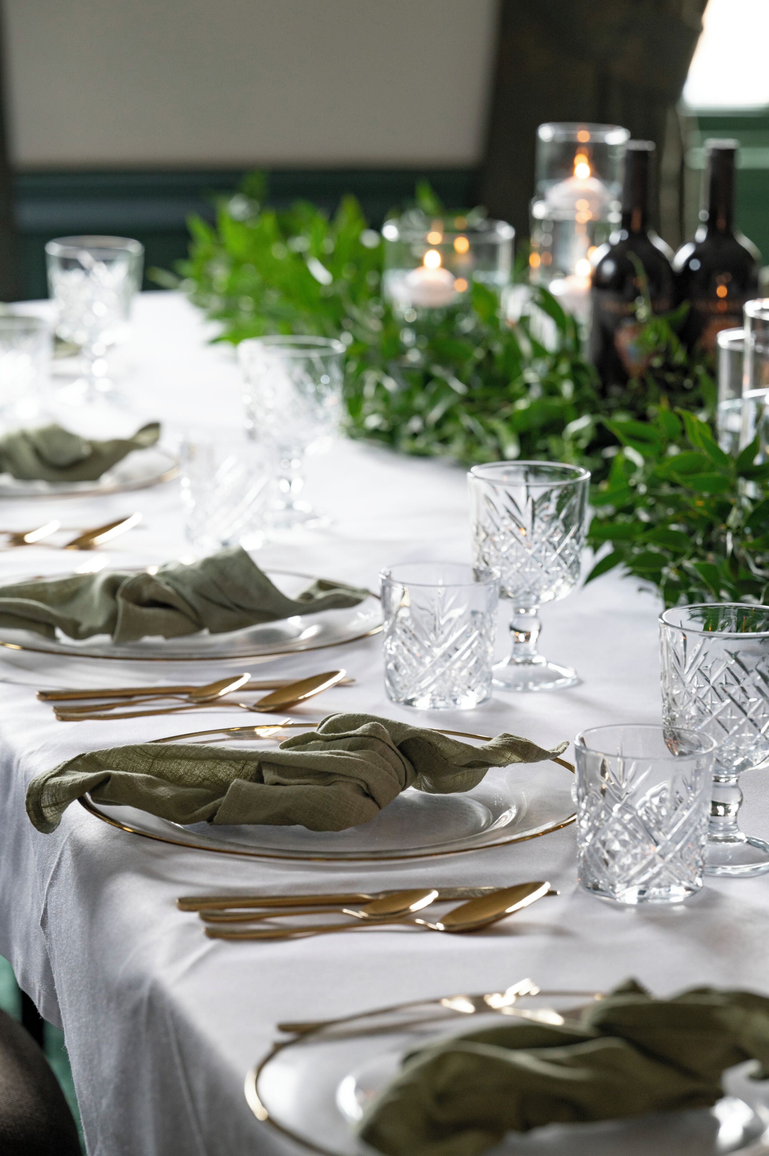 A table set for dining with plates, cutlery, and glasses.