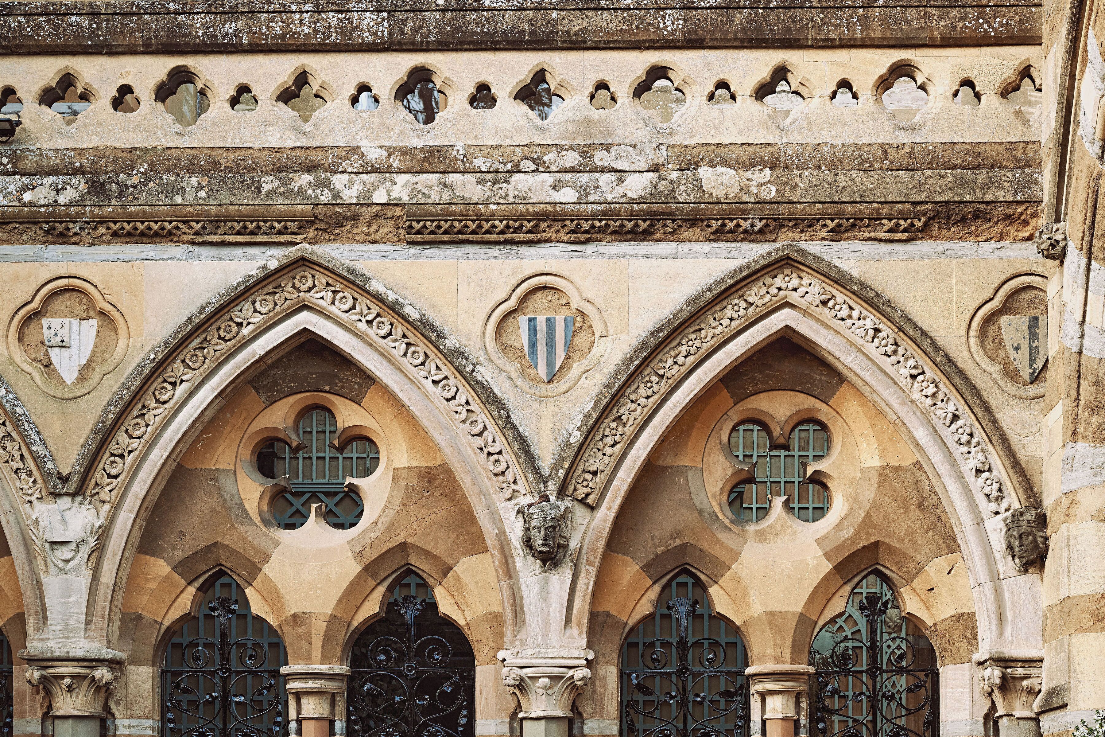 A stone building with arched windows and decorative stonework.
