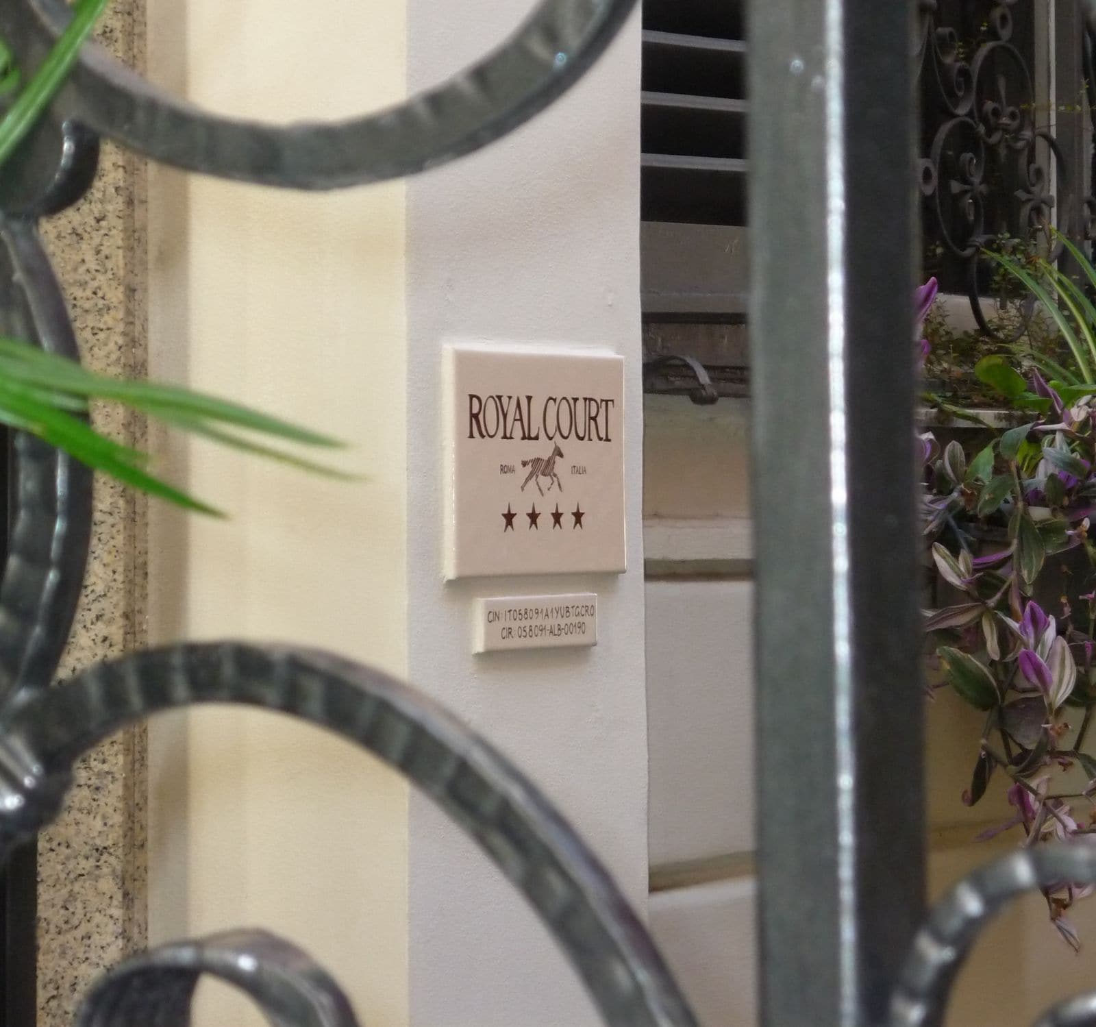 A sign with the text 'ROYAL COURT' and a horse symbol, indicating a hotel or establishment named Royal Court.