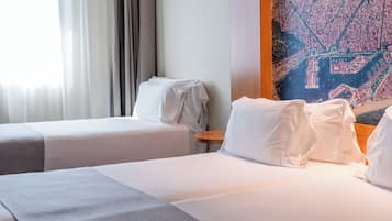 A hotel room with two beds, a wooden headboard, and a large cityscape painting on the wall.